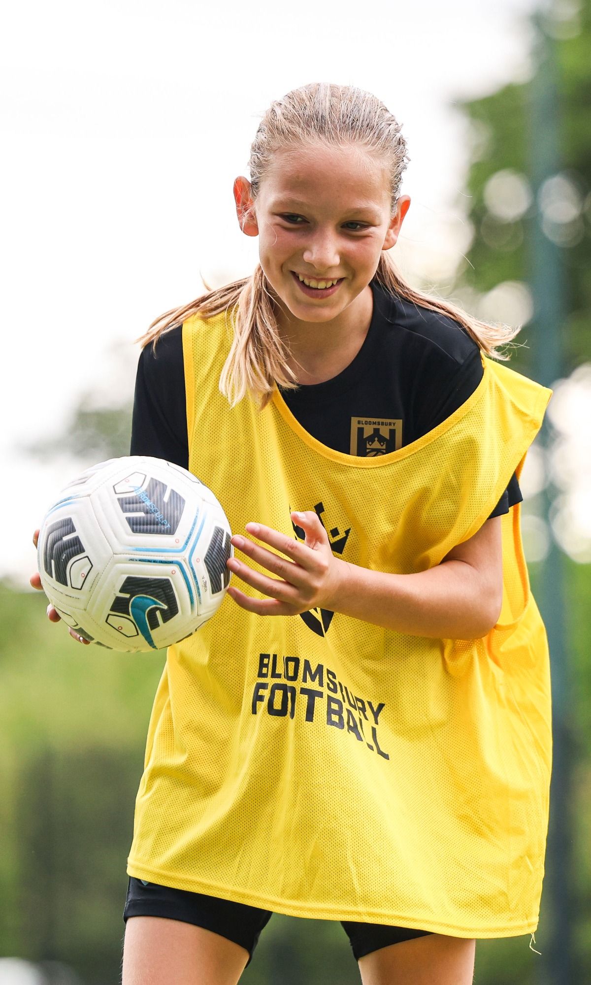 Bloomsbury Football Foundation player smiling holding football